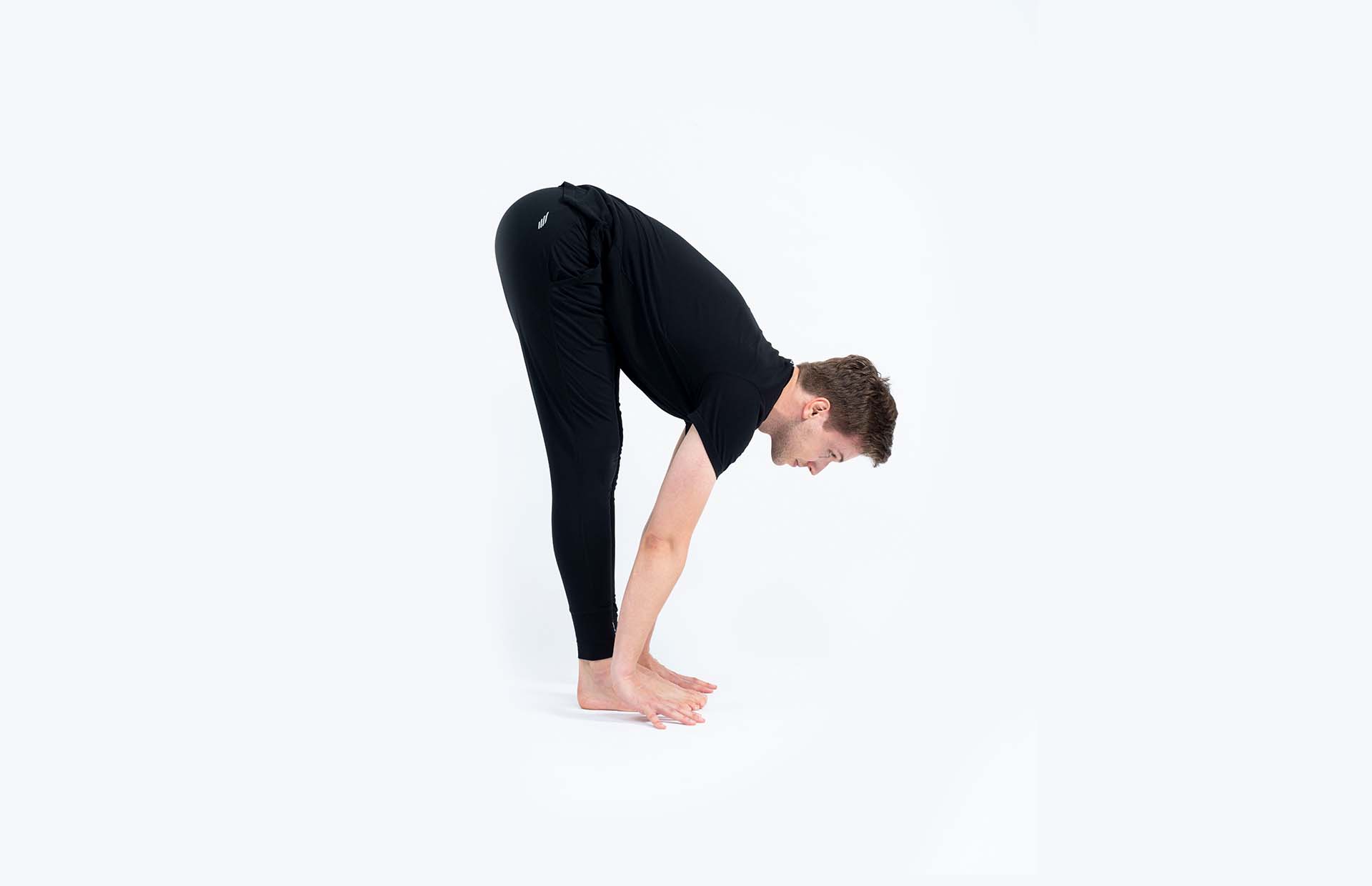 A person folding over legs with back extending, looking forward (Ardha Uttanasana)