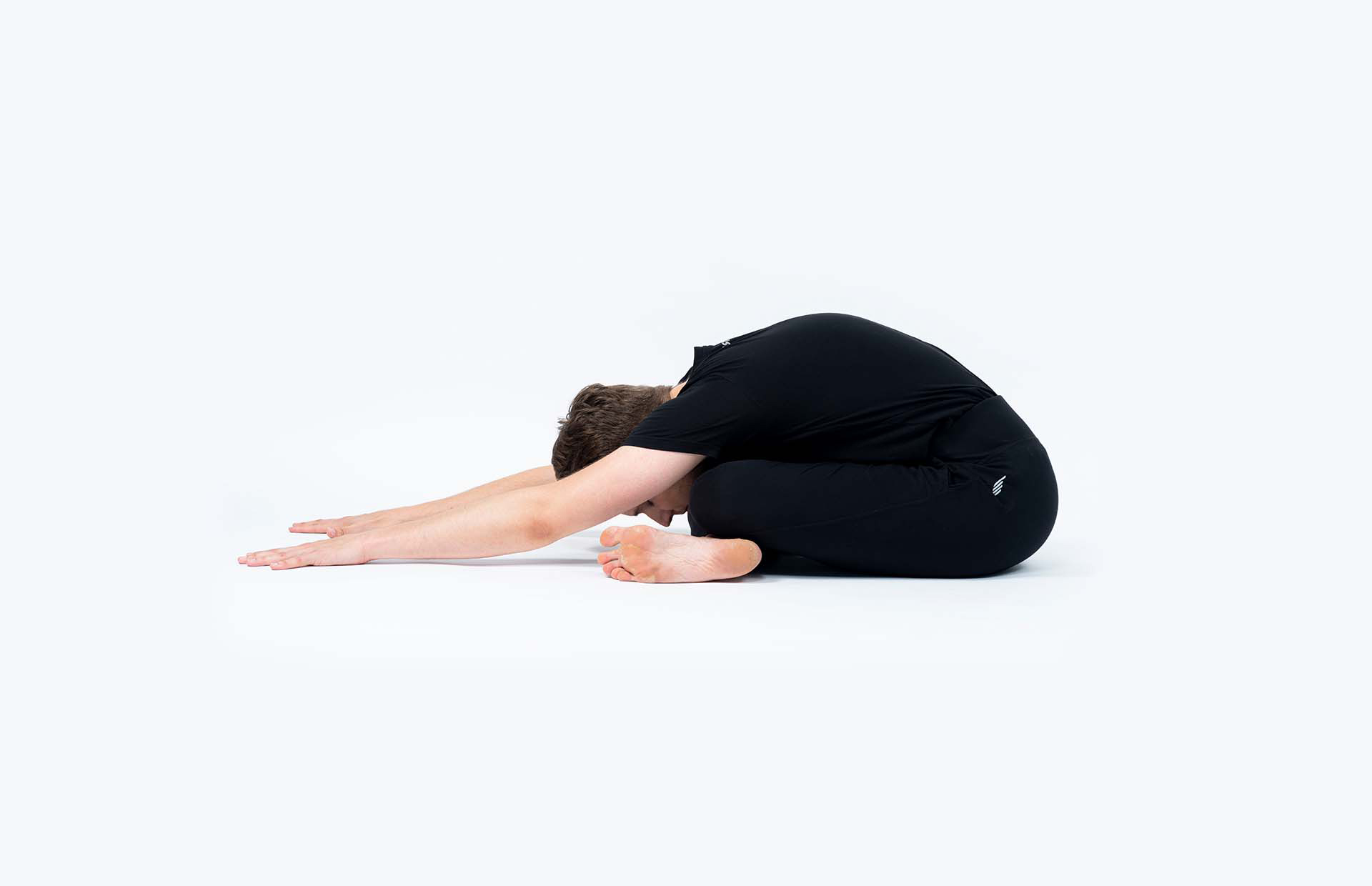 A person in Agnistambhasana (Ankle to Knee Pose)